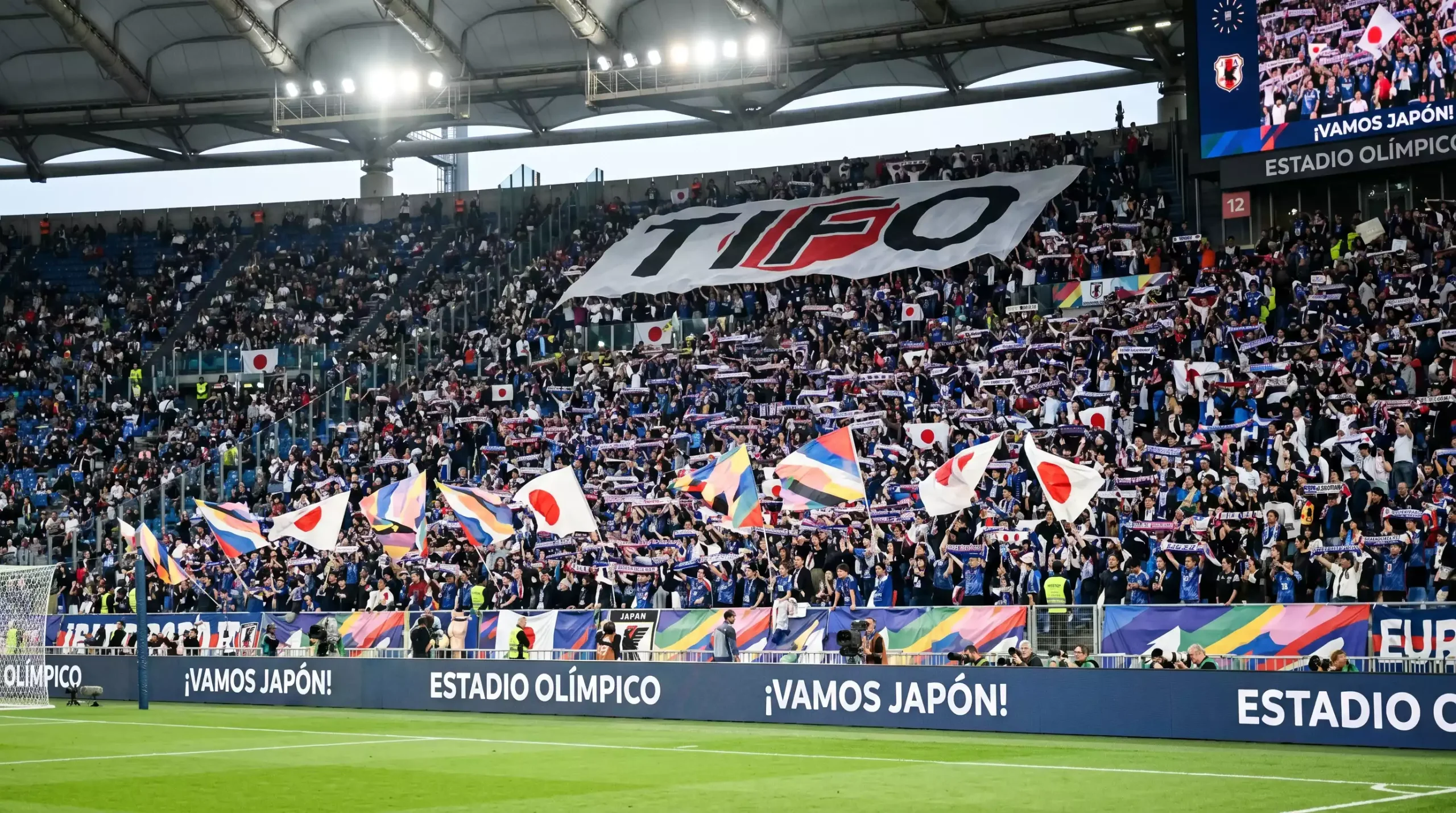 Afición japonesa llenando las gradas de un estadio de fútbol con banderas y bufandas durante un partido de la J.League